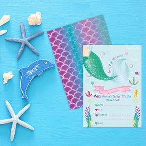 Mermaid birthday party invitation set with scale patterns on blue wood background