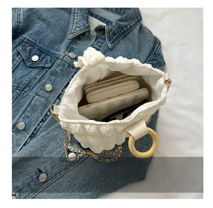 Top view of white bubble puff handbag interior showing wallet, phone, and sunglasses storage