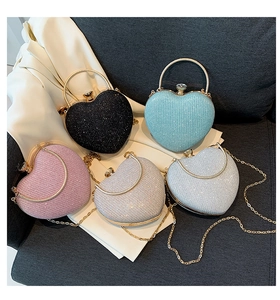 Glittering heart-shaped evening bags in five colors with metal handles and chain straps