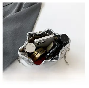 Interior view showing large capacity of the quilted silver bucket bag with chain strap