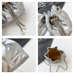 Detailed views of silver quilted bucket bag with pearl drawstring and metal chain strap