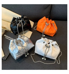 Quilted mini bucket bag details with drawstring closure and elegant pearl pendants