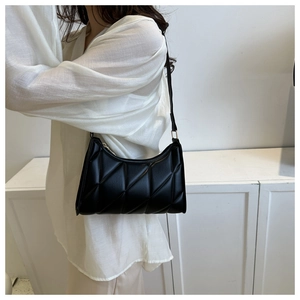 Detail of classic black quilted underarm bag with smooth zipper and premium PU texture