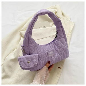 Detail of lavender quilted handbag with wave texture and detachable mini coin purse