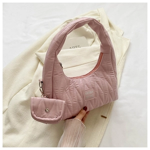Detailed shot of pink quilted fabric handbag with matching mini coin purse attachment