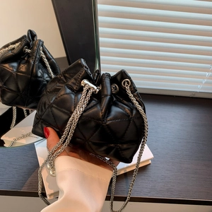 Quilted black drawstring bucket bag with silver snake chains and diamond stitch texture