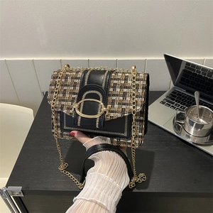 Classic tweed and leather crossbody bag with gold chain strap shown in a modern office setting