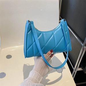 Vibrant blue quilted shoulder bag with diamond stitching and sleek minimalist design