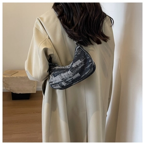 Detailed back view of a vintage denim half-moon underarm bag with black and white texture