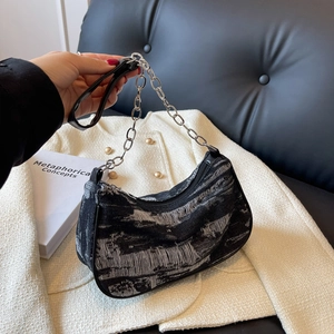 Denim crescent shoulder bag with silver chain strap and distressed grey fabric texture