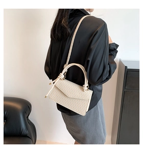 Minimalist creamy white pleated handbag shown on model for back-view styling