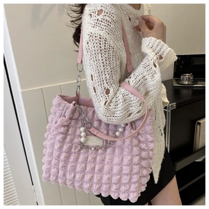 Pink tote bag detail with textured bubble fabric, decorative pearls and silver chain strap