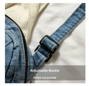Detail of adjustable black buckle and premium light blue denim fabric on crossbody bag