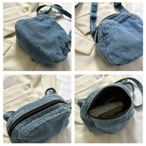 Detail view of denim crossbody bag showing interior space for umbrella and wallet