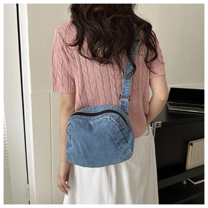 Rear view of a casual blue denim crossbody bag with double zippers for women