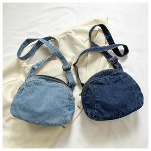 Detailed comparison of light and dark blue denim crossbody bags with adjustable straps