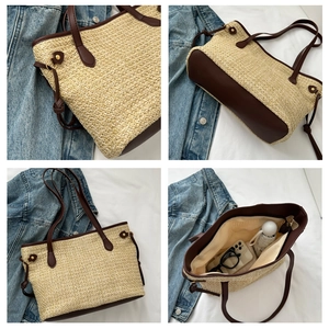 Detail view of large straw tote bag with brown PU trim showing spacious inner lining