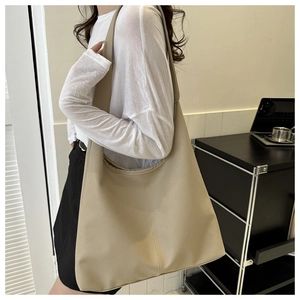 Detail of beige hobo tote bag showing soft pebble leather texture and spacious design