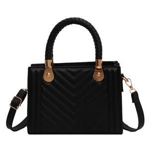 Chic black V-quilted handbag with woven handles and gold hardware in crossbody style