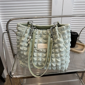 Light green ruched tote bag with pearl metal chain and textured bubble fabric finish