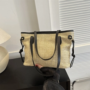 Straw tote bag with black leather straps and trim for summer casual shoulder wear