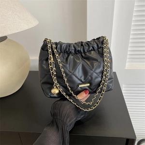 Black quilted leather shoulder bag with gold chain strap and stylish pleated detail