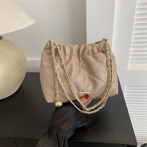 Quilted beige pleated shoulder bag with gold chain straps and a soft textured finish