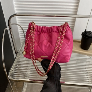 Fuchsia quilted leather shoulder bag with drawstring closure and gold chain strap