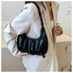 Detail of black ruched crescent underarm bag with unique braided knot handle design