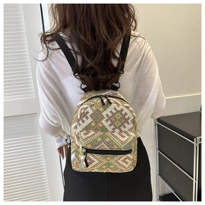 Rear view of a compact ethnic style backpack featuring colorful geometric jacquard patterns