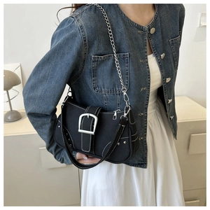 Detail of black canvas bag featuring Y2K metal buckle and contrast stitching accents
