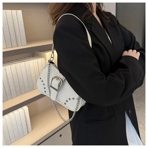 Minimalist cream canvas shoulder bag featuring silver buckle detail and chain strap accents