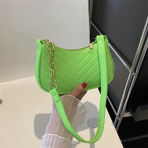 Neon green crescent shoulder bag with V-shaped quilting and gold metal chain strap