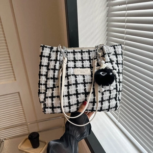 Large black and white plaid tweed tote bag with chain strap and plush monster charm