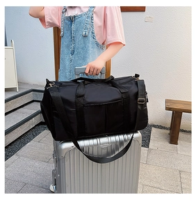 Black travel bag with trolley sleeve attachment shown on luggage handle for easy transport