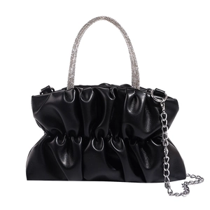 Black pleated cloud handbag with shimmering rhinestone handle and silver chain strap