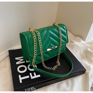 Detail of green chevron quilted shoulder bag with gold chain strap and metal lock