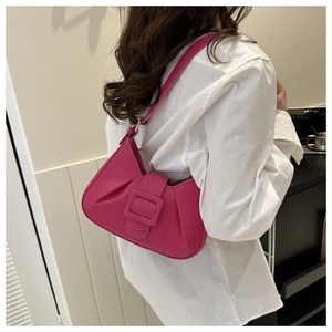 Detail of fuchsia pleated underarm bag with matching large buckle on high quality PU leather
