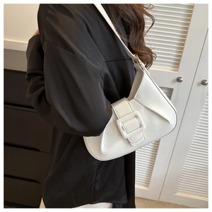 Detail of white half-moon hobo bag with pleated leather texture and large square buckle