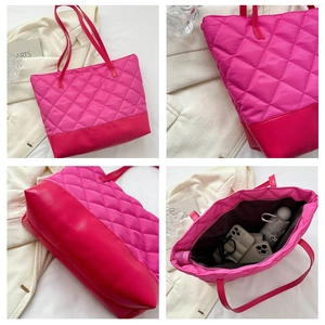 Macro detail of quilted rose red tote bag showing fabric texture and large inner capacity