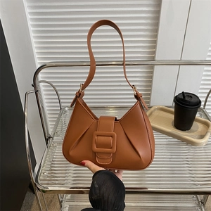 Brown minimalist underarm shoulder bag with pleated details and large buckle