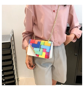 Close-up of color-block geometric pattern crossbody bag with elegant gold chain strap
