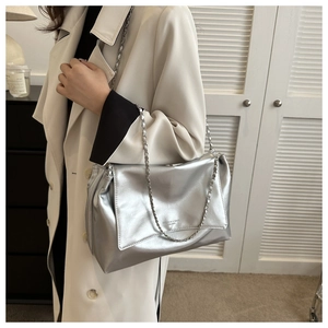 Close-up of a silver chain shoulder bag with metallic PU leather and chain strap details