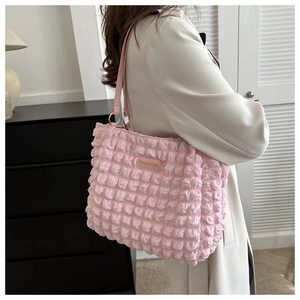 Detail of pink bubble texture tote bag with FASHION label and thin leather shoulder strap