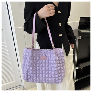 Detail of lavender bubble textured tote bag with elegant fashion shoulder strap