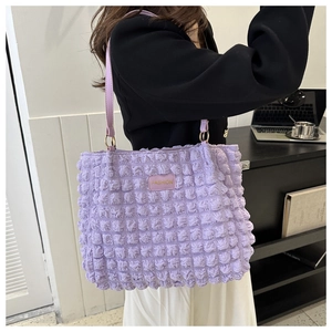 Detail of light purple pleated tote bag with bubble texture and FASHION label