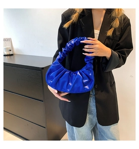 Detail of the bright blue crescent cloud bag with pleated design and soft PU leather texture