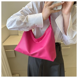Magenta faux leather crescent underarm bag shown on model with white shirt
