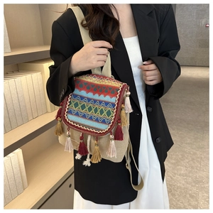 Close-up of ethnic style backpack with colorful embroidery and tassel detail