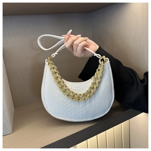 Detail of white crocodile embossed crescent bag with chunky gold chain handle